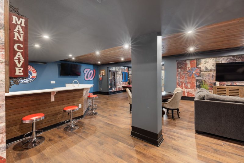 Blog 9 Modern man cave featuring a sleek bar, sports decor, and comfortable seating.