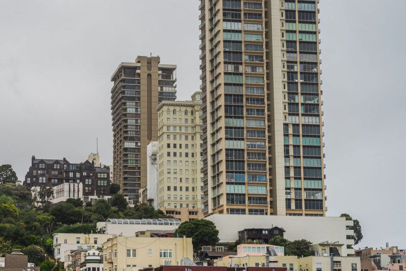 San Francisco cityscape showcasing modern residential towers and sleek architectural designs against a clear sky.