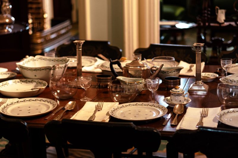 Home 13 Elegant dining room table set with fine china and silverware, ready for a formal meal.